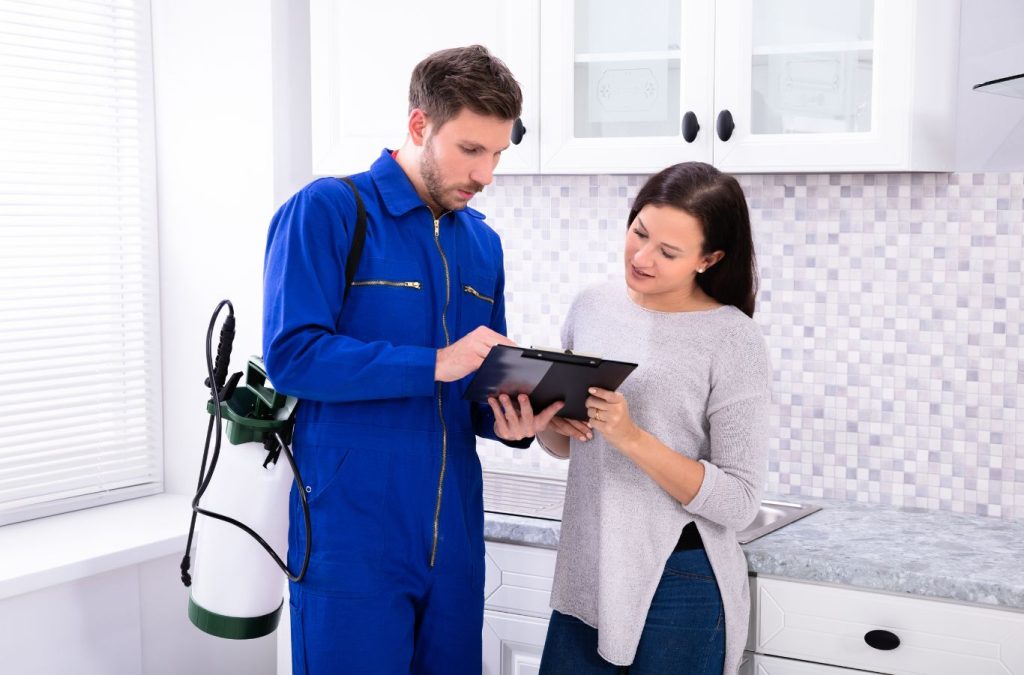 Technician explaining pest control benefits to a customer in Bonita Springs, FL. Pest control near me.